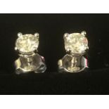 A pair of 18ct gold diamond stud earrings, the fine claw set stones weighing over half a carat,