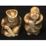 A small bearded netsuke carved as a grumpy seated gentleman holding tool; and another depicting a