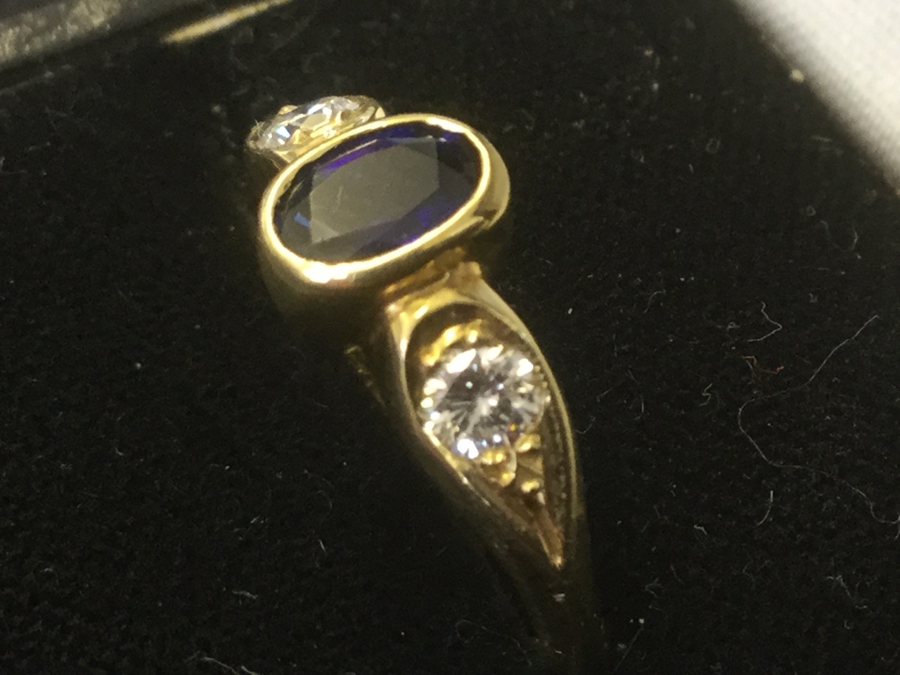An 18ct gold sapphire & diamond three stone ring, the bezel set oval sapphire flanked by teardrop - Image 3 of 3