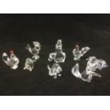 A collection of Swarovski miniatures - a hippo; a puppy with frosted tail; an anteater with black