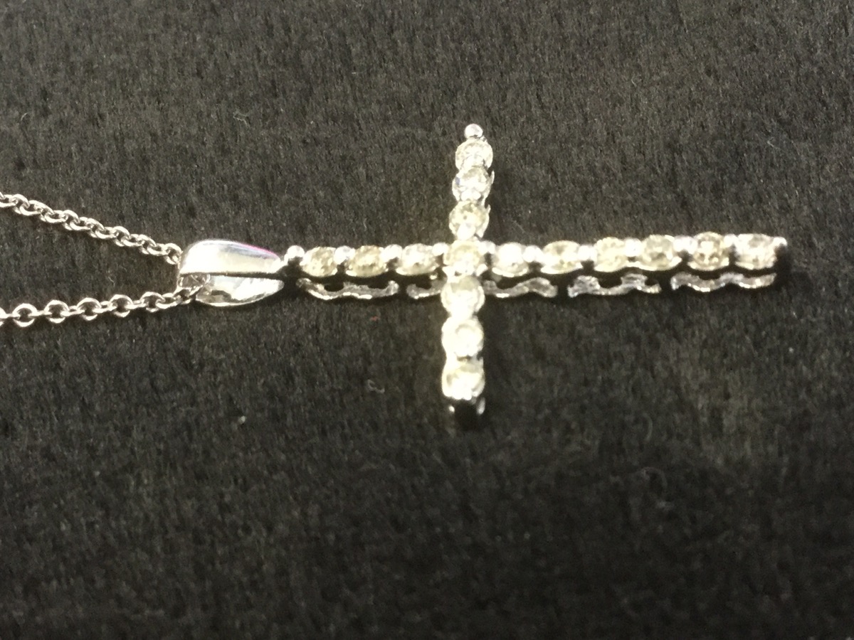 A platinum and diamond crucifix, the cross set with diamonds, mounted on a fine 18ct gold chain. ( - Image 2 of 3