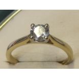 An 18ct gold diamond ring, the single stone weighing half a carat, the diamond claw set on a
