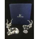 A Swarovski standing mountain ibex with frosted horns & base; and a prone kudu antelope with frosted