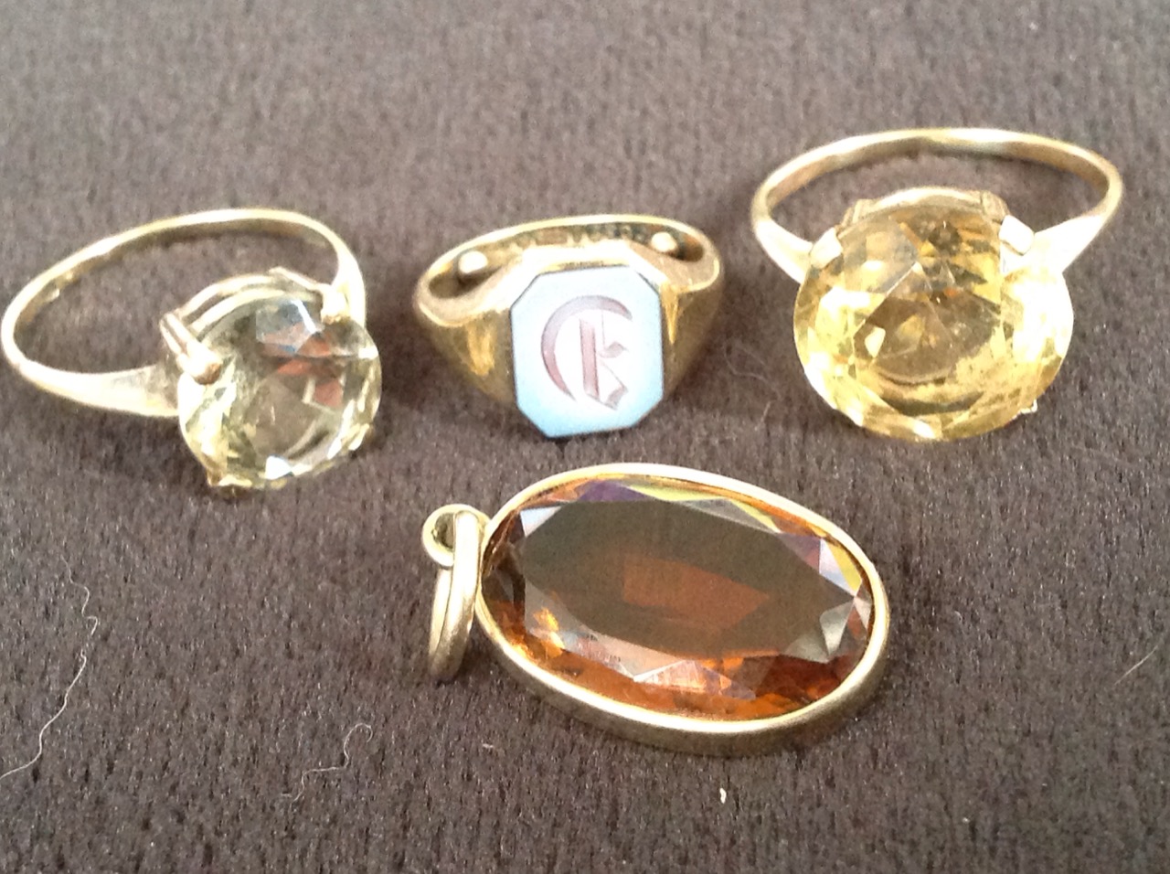 Two hallmarked gold rings claw set with large circular clear stones; a small 9ct gold signet ring