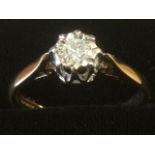A 9ct gold diamond ring, the crown set brilliant cut circular stone raised in a white gold cage,
