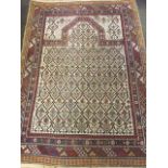 An Eastern oriental prayer rug, the field woven with rows of flowers on beige ground, framed by
