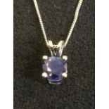 An 18ct gold sapphire pendant, the single circular claw set stone of over three-quarters of a carat,