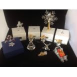 Swarovski Christmas memories including a Christmas tree topper with star crystals; three angel