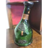 A large 1937 armagnac bottle, the weighted novelty green glass embossed 'Exposition Universelle',