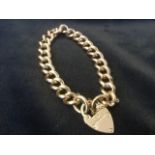 A hallmarked gold bracelet, the links all stamped 9ct, with heart shaped padlock clasp - 17.5g. (