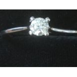 A platinum diamond ring, the claw set circular stone of 0.20 carats, on tapering plain hallmarked