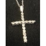 A platinum and diamond crucifix, the cross set with diamonds, mounted on a fine 18ct gold chain. (