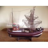 Seestern, a wood model trawler, the boat with hoisted fishing nets, mounted on stand.