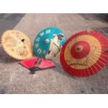 Three Chinese paper & bamboo parasols decorated with geishas, flowers and dragons; and a paper fan