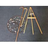 An beech artists easel on three legs; a hazel shepherds crook; a circular wall decoration with