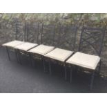 A set of five metal conservatory chairs with cross-slatted backs and loose cushion seats, raised