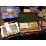 A quantity of games including a boxed mar-jongg set, a cribbage board, boxed jigsaws, scrabble, a