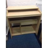 A modern computer desk, having rectangular top above a sliding shelf, with compartments and drawer