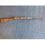 A flintlock rifle, the wallpiece with brass mounts.