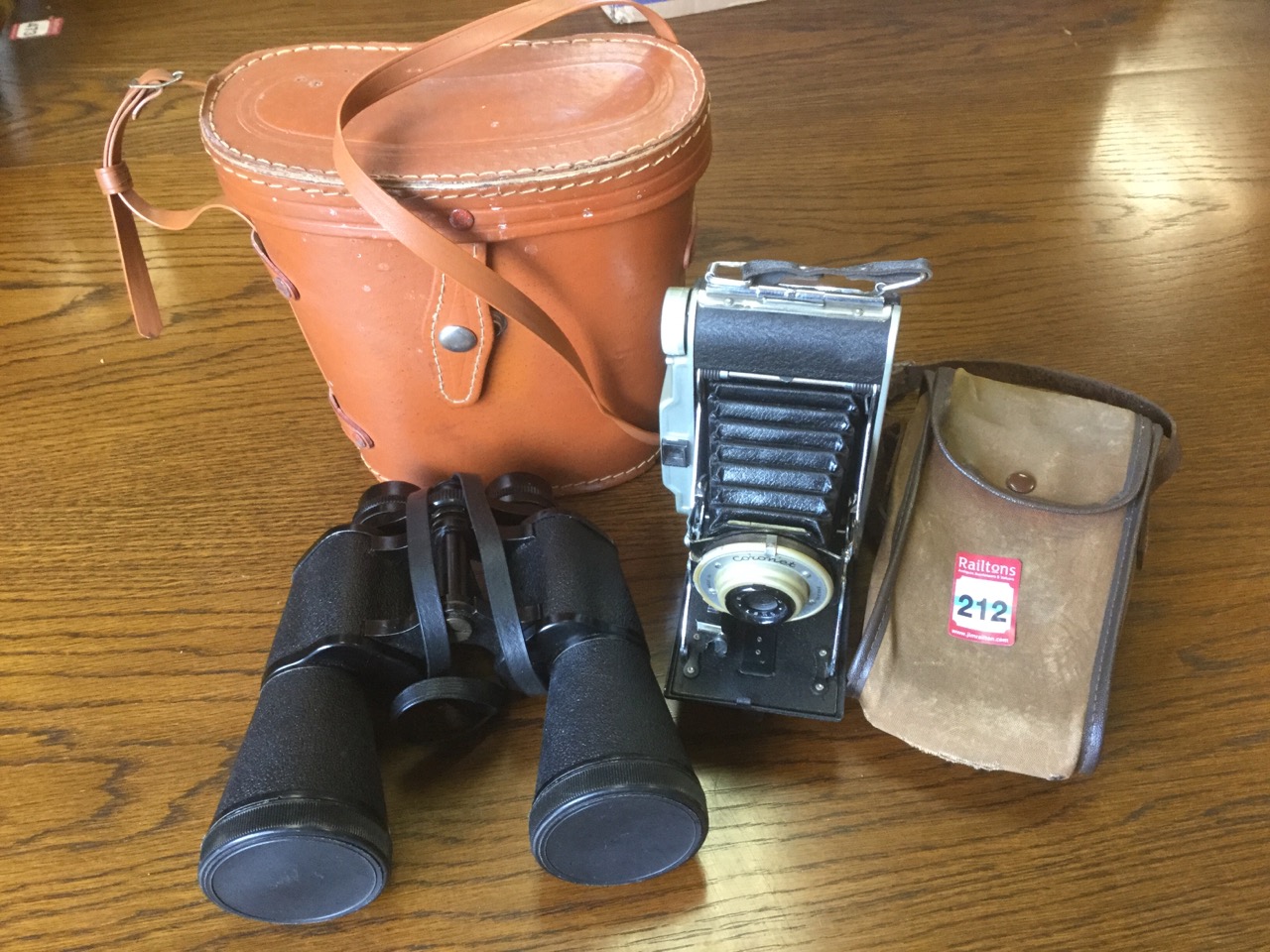 A Coronet Rapide camera with concertina action complete with case; and a pair of Grosvenor