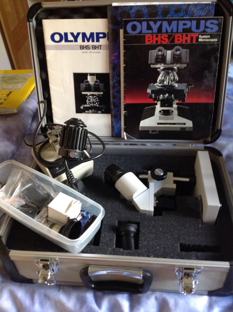 A cased Olympus BHS/BHT system microscope, complete with light, lenses, etc. (A lot)