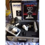 A cased Olympus BHS/BHT system microscope, complete with light, lenses, etc. (A lot)