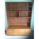 A 70s teak dresser, the back with open shelves above a base with six drawers, supported on a