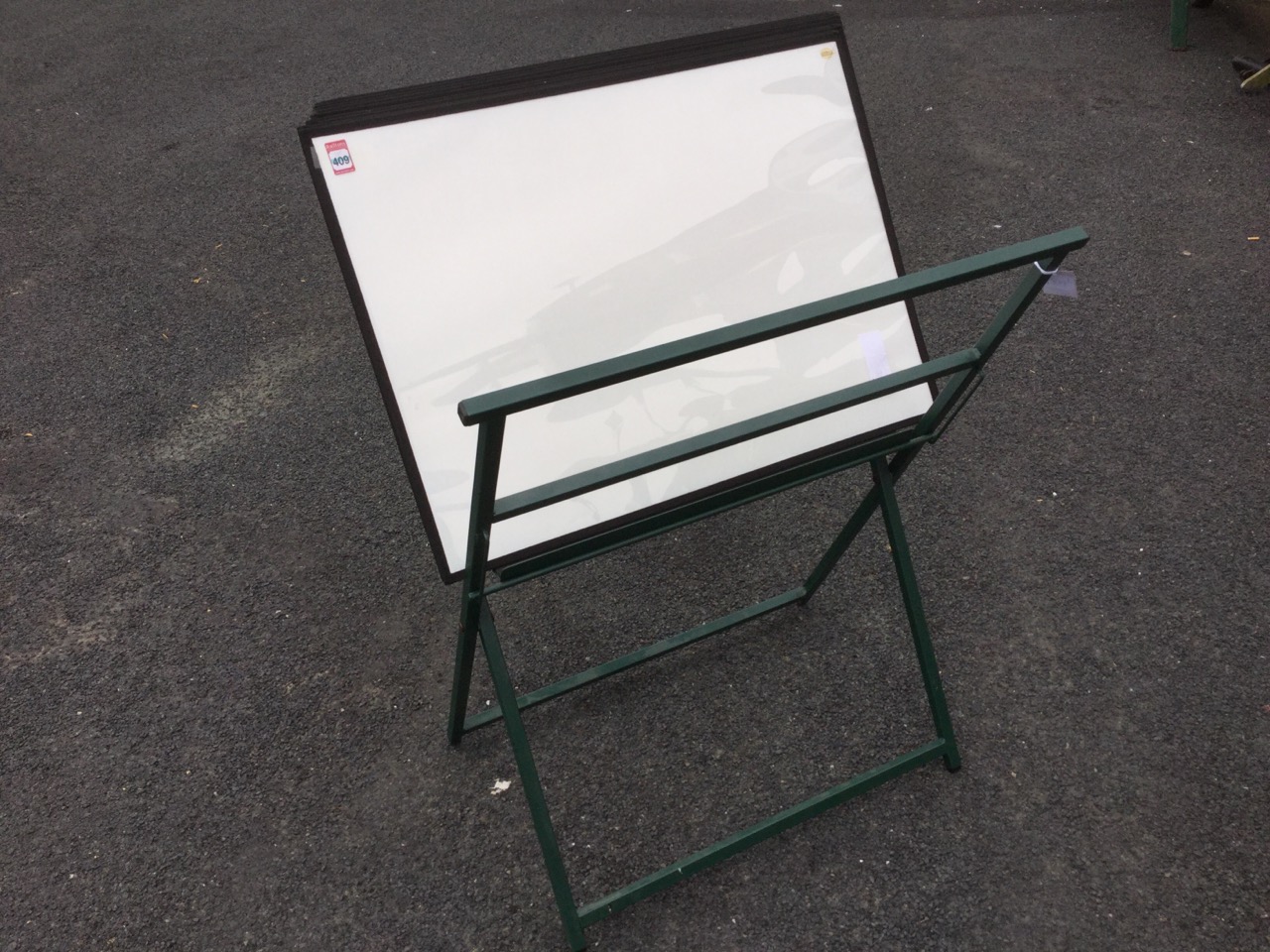 A picture display stand with clear plastic sleeves for selling prints/pictures, the folding easel