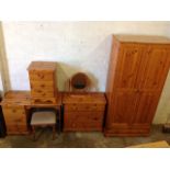 A pine six-piece bedroom suite with wardrobe, kneehole dressing table, stool, chest of drawers, oval