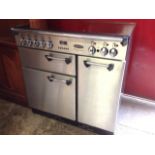 A Rangemaster Professional cooker, the glass top with five cooking rings, having three ovens below