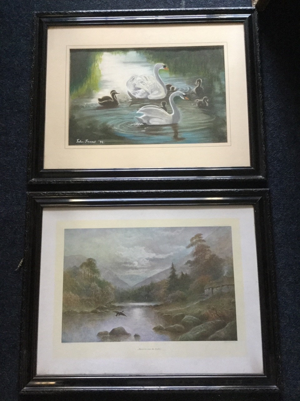 A John Jones print depicting swans on a lake, dated 92; and a JWGozzard print titled Moonrise over