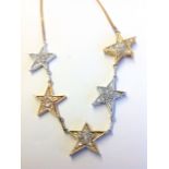 A 14ct tri-colour gold and diamond star necklace, the diamonds pave set within the stars, mounted on