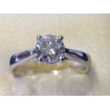 An 18ct gold diamond ring, the brilliant cut round diamond weighing over a carat, the stone claw set