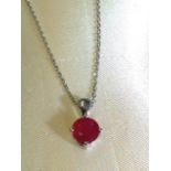 An 18ct white gold ruby pendant, the single circular claw set stone of over three-quarters of a