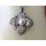 An 18ct white gold diamond & pearl pendant, the pearl framed by white gold petals pave set with