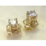 A pair of 18ct yellow gold diamond stud earrings, the brilliant cut claw set stones weighing under