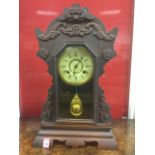 An American mantle clock by the New Haven Clock Company, with fretwork crest having applied scroll