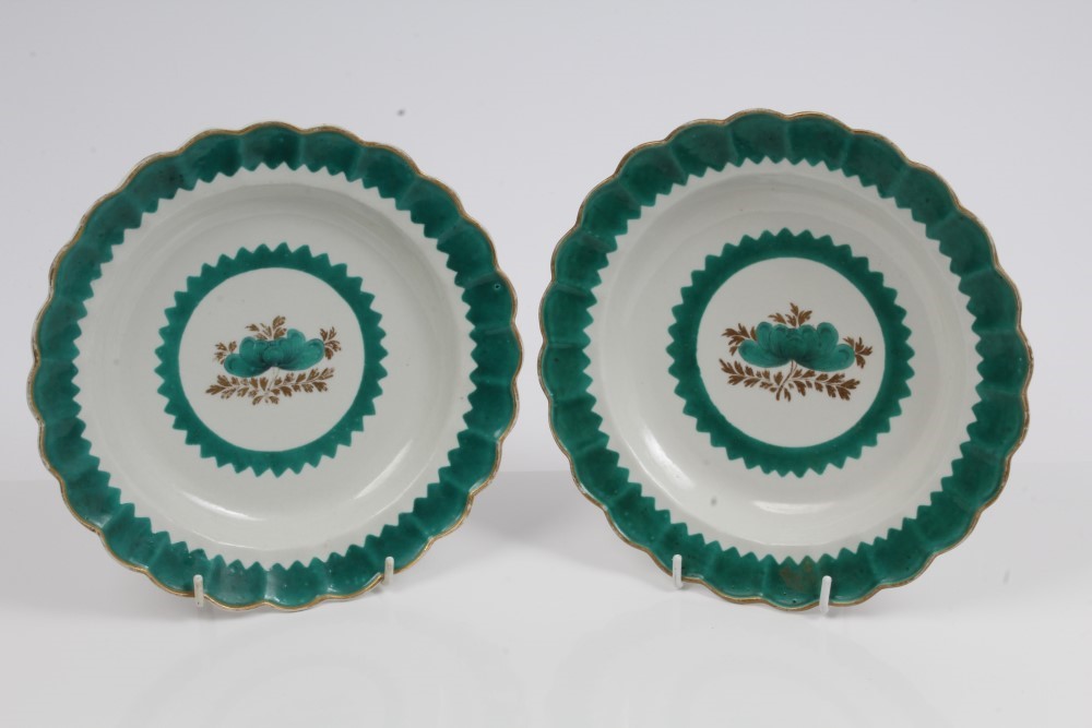 Pair 18th century Worcester green and gilt bordered plates with fluted borders and central floral