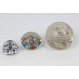 Small 19th century French glass paperweight with flower-head canes and faceted sides and top,