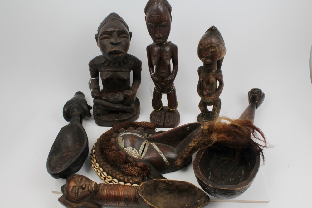 Group of African tribal sculptures including metal and shell mounted Dan mask,
