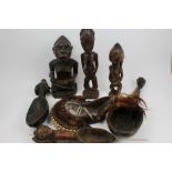 Group of African tribal sculptures including metal and shell mounted Dan mask,