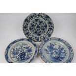 Three 18th century Delft blue and white tin glazed chargers - one decorated with stylised tulips