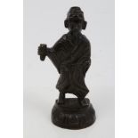 Antique Chinese provincial bronze figure of a scholar modelled standing on lappet moulded plinth,