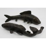 Two early 20th century Japanese bronze carp ornaments, naturalistically modelled,