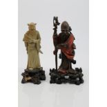 Chinese polychrome lacquered carved figure of Shou Lao, with staff in hand, on pierced rocky base,