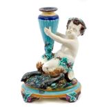 Victorian Wedgwood Majolica candlestick in the form of a Bacchanalian fawn holding an amphora with