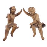 Two Continental antique lime wood carvings of putti,