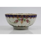 18th century Worcester fluted bowl with painted floral scrolls within gilt and two-colour blue