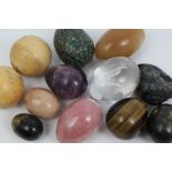 Collection of specimen mineral eggs - including tiger's eye, quartz and others,