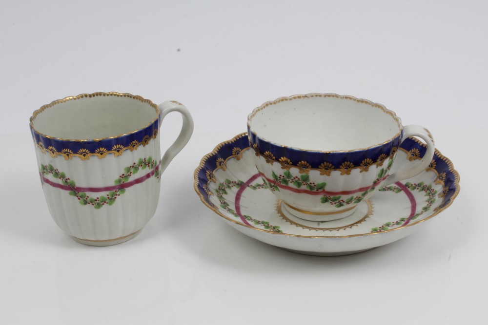 18th century Worcester fluted trio with painted garlands of flowers with blue and gilt borders - - Image 2 of 3